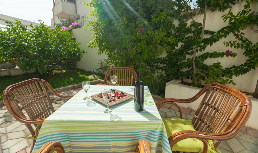 Terrace with dining table and bougainville