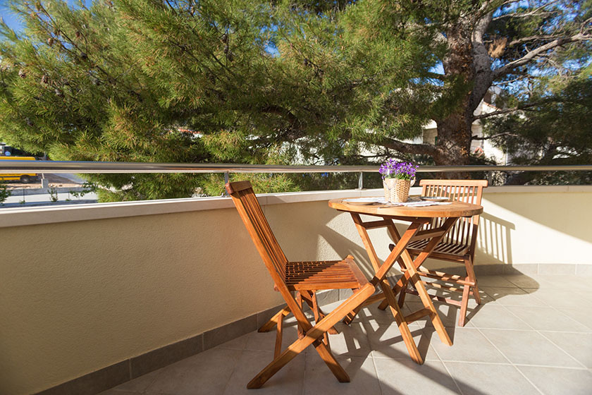 Balcony with pine tree and dining table