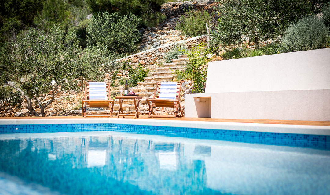 Swimming pool with wooden chairs